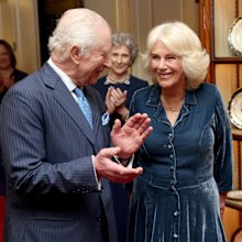 LONDON, ENGLAND - MARCH 25: King Charles III and Queen Camilla laugh during a reception to mark the launch of the Queen's reading room medal at Clarence House on March 25, 2025 in London, England. 
