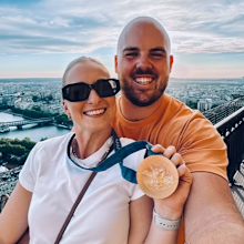Matthew Denny and Mia Denny hold his bronze Olympic medal in Paris