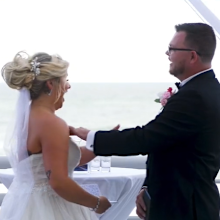 Bride and groom interrupted by bird at wedding