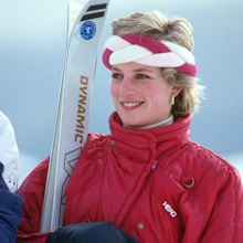 KLOSTERS, SWITZERLAND - FEBRUARY 06: Diana, Princess of Wales, wearing a red ski suit by Head and a braided headband, holds her skis and poles during a holiday in Klosters on February 6, 1986 in Klosters, Switzerland. (Photo by Anwar Hussein/Getty Images)