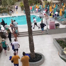 holidaymakers in spain running towards sunbeds