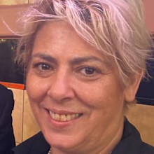 The woman allegedly stabbed to death by her housemate inside a home in Sydney's Inner West has been identified as 53-year-old Annette Kiss.