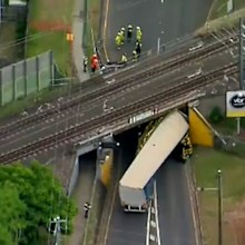 New footage shows truck topple and get jammed under Brisbane bridge