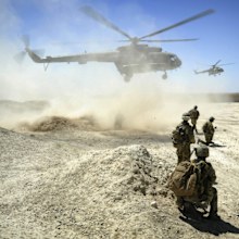 Australian Defence Force, members of the National Interdiction Unit  and the Special Operations Task Group await the arrival of two Mi-17 helicopters in Kandahar, Afghanistan.