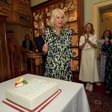 LONDON, ENGLAND - JULY 9: Queen Camilla cuts a cake to celebrate the National Literacy Trust charity's 30th anniversary at Clarence House on July 9, 2024 in London, England. (Photo by Yui Mok - WPA Pool/Getty Images)