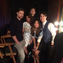 Darren Criss behind the scenes with castmates while filming Glee.