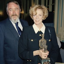 UNITED KINGDOM - CIRCA 1994: English actress Maggie Smith (R), winner of the Best Actress award for "Three Tall Women" poses with her husband, playwright Beverley Cross (1931 - 1998), at the Evening Standard Drama Awards, November 1994, in London, England. (Photo by Dave Benett/Getty Images)