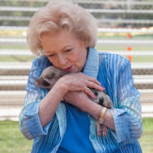 Betty White holding piglet