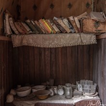 And old bookshelf with personal trinkets underneath.