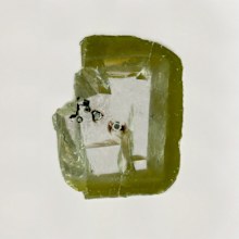 The diamond holds tiny black specks of Davemaoite, which is formed at high heat and high pressure deep inside the Earth. (Aaron Celestian, Natural History Museum of Los Angeles County).