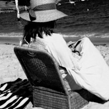 Nikki Gemmell sitting on a chair at the beach