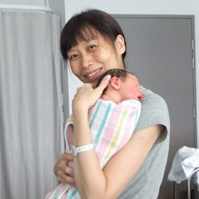 Melody Tan poses with her newborn.