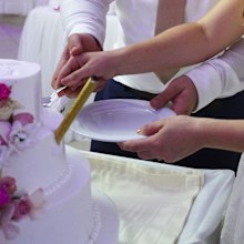 bride and groom cutting wedding cake