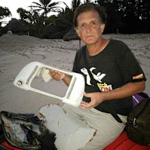 Blaine Gibson with the housing for a TV monitor from the back of a seat inside the missing plane.