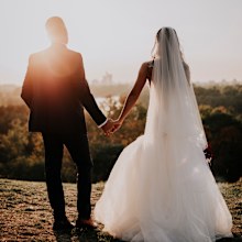 Bride and groom holding hands.