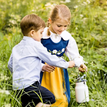 The siblings were photographed collecting wild flowers.