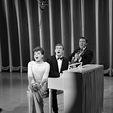 Judy Garland performs with The Allen Brothers (Peter Allen and Chris Bell) in 1965. Peter Allen plays piano. Chris Bell plays guitar.