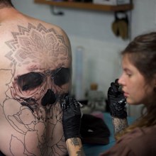Jody Knight works on a huge back tattoo.
