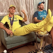Mitchell Marsh with his feet resting on the World Cup trophy after Australia's victory over India.