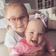 Emilia at about one year old with her sister Myra.