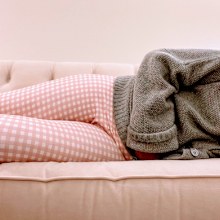 Woman lying down due to period pain.