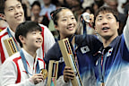 Athletes from North Korea and South Korea take a selfie after the Table Tennis Mixed Doubles medal matches in Paris.