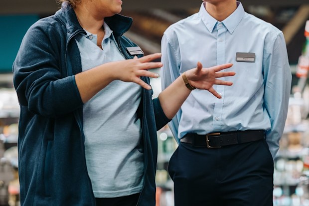 Store incharge training young worker. Supermarket manager giving training to a trainee.