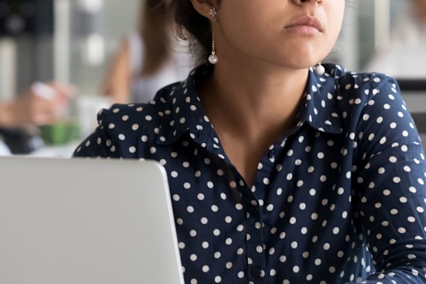 Woman sitting pensively at desk