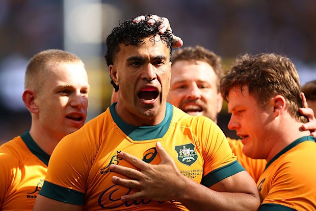 Joseph-Aukuso Suaalii of the Wallabies celebrates with teammates after scoring a try.