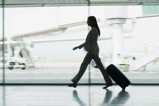 Woman business traveller walks with luggage at the airport
