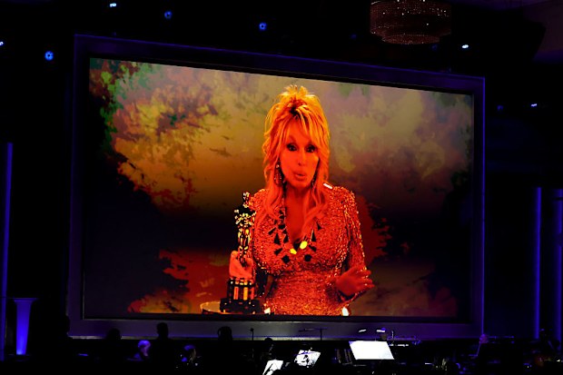 HOLLYWOOD, CALIFORNIA - NOVEMBER 16: Dolly Parton accepts an Academy Honorary Award via video during the 16th Governors Awards at The Ray Dolby Ballroom on November 16, 2025 in Hollywood, California. (Photo by Kevin Winter/Getty Images)