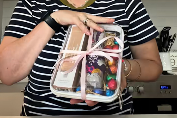 Mum and influencer Sophie Chalmer in a tiktok video, showing how she uses the two pack Kmart packing cubes to elevate her easter gifts. 