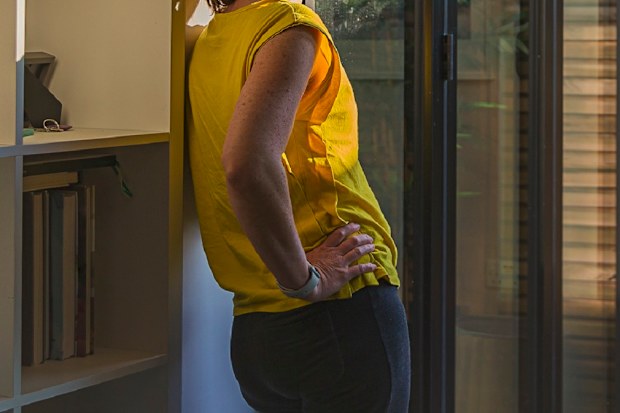 Anxious woman staring out window.
