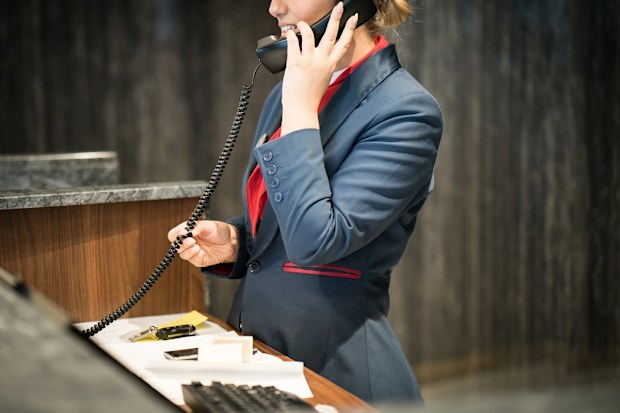 Female front of desk hotel worker.