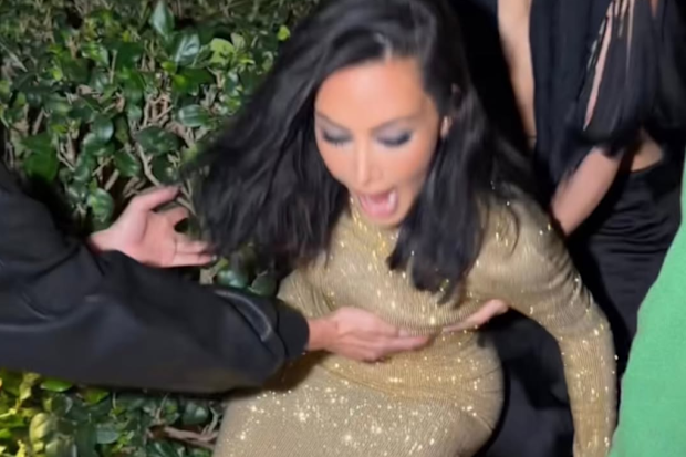 Kim Kardashian falls into a bush en route to 2026 Oscars after party.