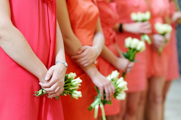 Row of bridesmaids with bouquets at wedding ceremony