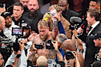 Jake Paul defeats Mike Tyson during their heavyweight world titles.