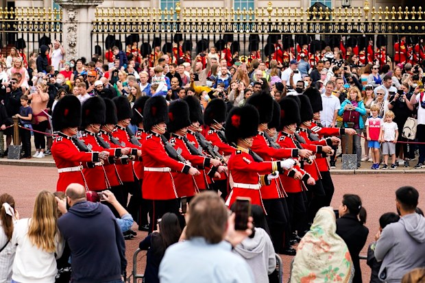 Spectators attend the first Changing the Guard outside Buckingham Palace, since the beginning of the Covid19 pandemic, in London.