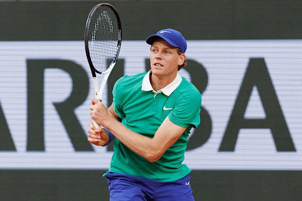 Jannik Sinner of Italy plays a backhand against Novak Djokovic of Serbia.