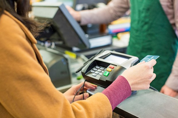 Woman paying for groceries.