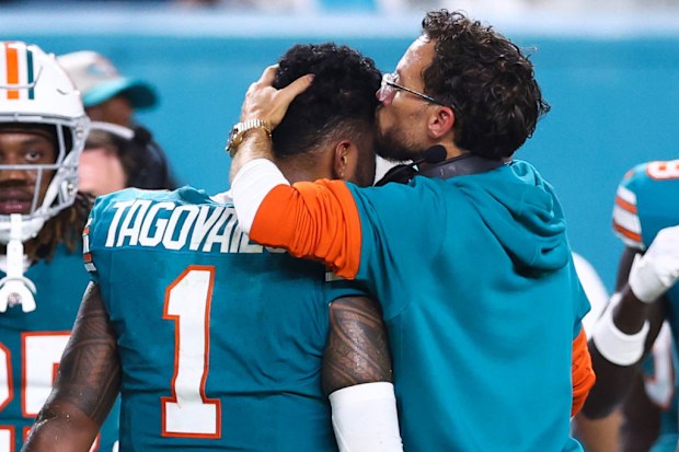 Head coach Mike McDaniel of the Miami Dolphins embraces Tua Tagovailoa #1 after leaving the game with an injury.