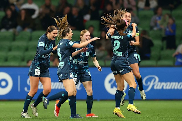 Shea Conn\u00adors celebrates with her teammates after scoring.