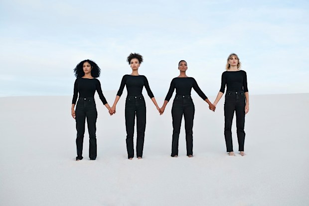 Women dressed in black holding hands
