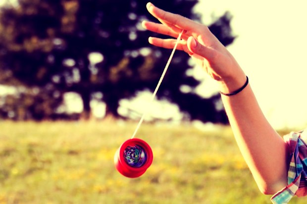 Female hand playing with a yoyo in motion.