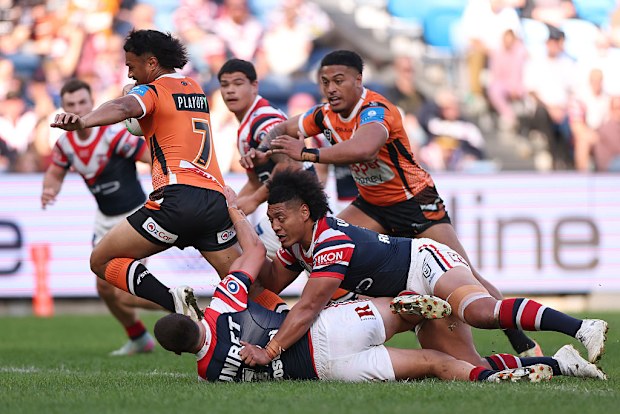 Latu Fainu of the Tigers makes a break.