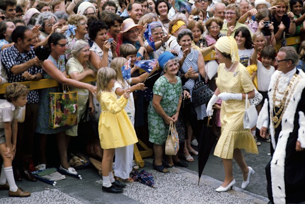 Queen Elizabeth II, carrying her own umbrella, is accompanied by the Lord Mayor of Brisbane, Alderman Frank Sleeman, as she goes walkabout in the streets of Brisbane, during her Silver Jubilee tour of Australia.   (Photo by Ron Bell/PA Images via Getty Images)