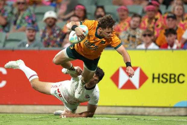 Henry Palmer of Australia dives for a try.