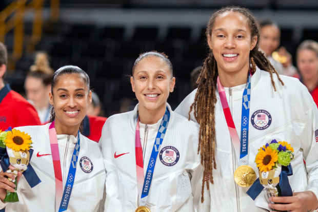 Skylar Diggins-Smith (left), Diana Taurasi (centre) nd Brittney Griner (right) with their gold medals after the Japan V USA basketball final at the Tokyo 2020 Olympic Games.