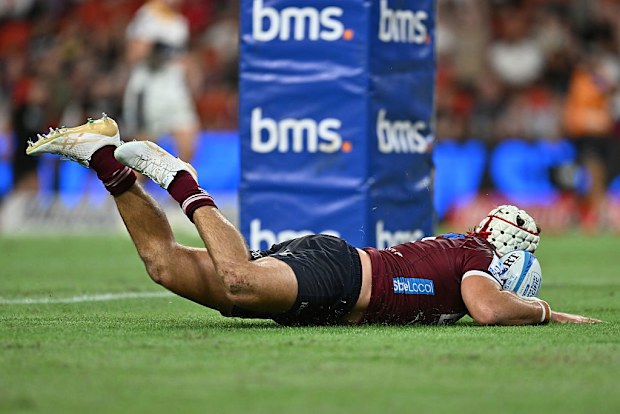 Fraser McReight of the Reds scores a try.