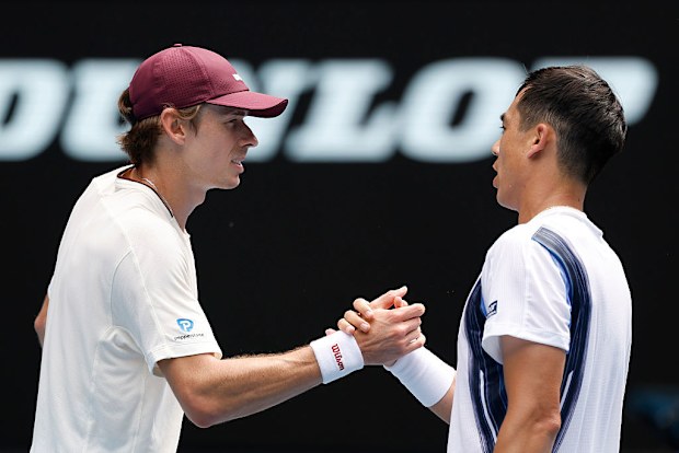 Alex de Minaur (L) of Australia shakes hands with Mackenzie McDonald (R) of the United States.